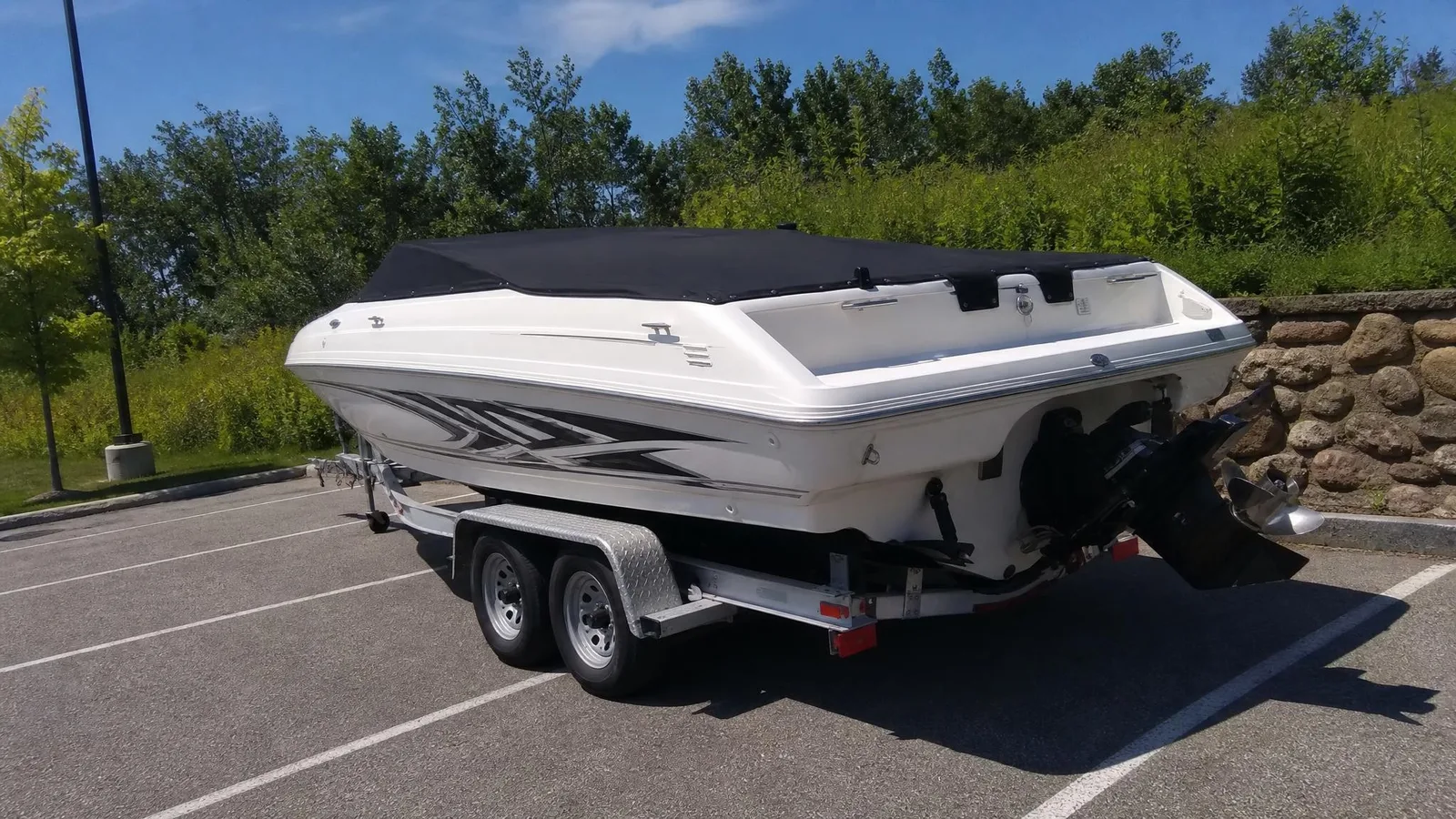 Source photo of a white speedboat on its trailer, 2 of 2, taken on a phone