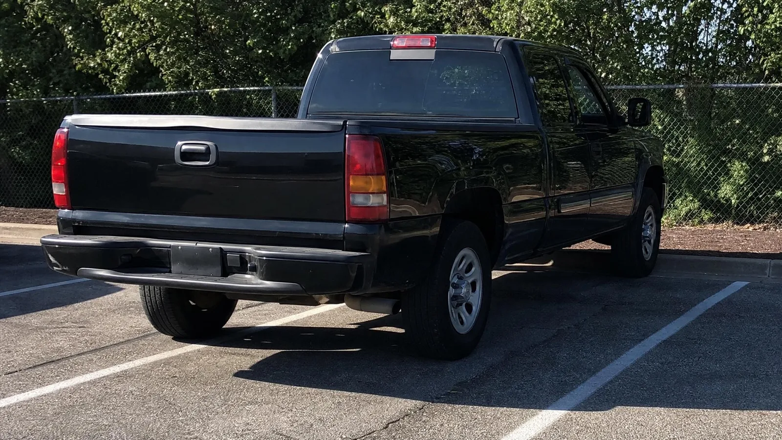 Source photo of a black pickup truck, 1 of 2, taken on a phone