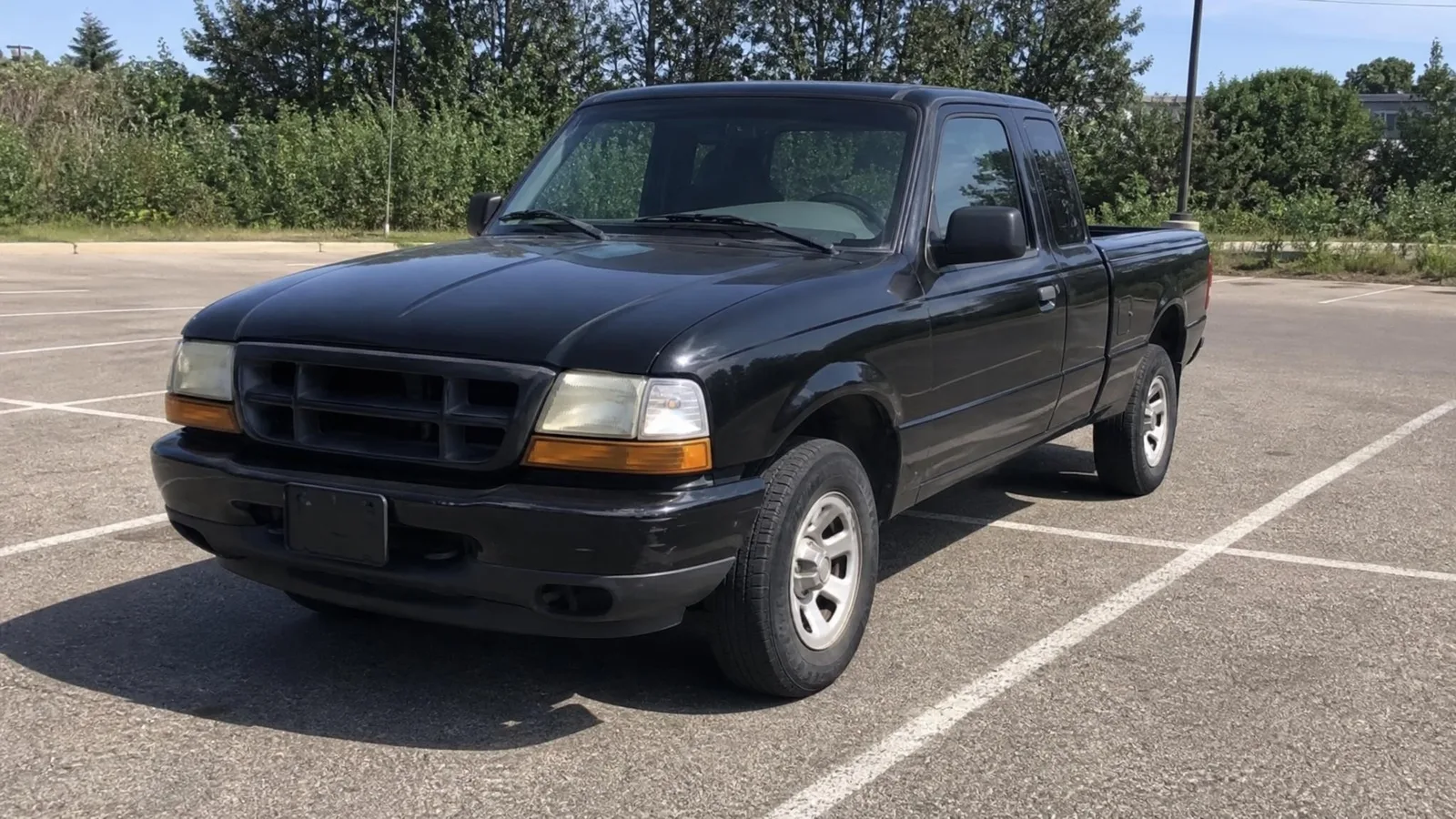 Source photo of a black pickup truck, 2 of 2, taken on a phone
