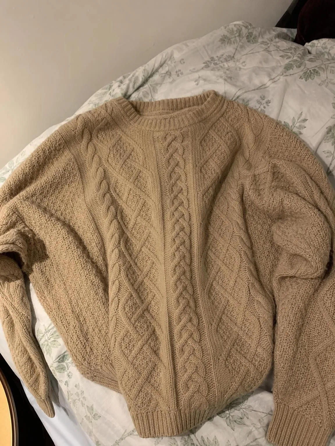 Source photo of a beige cable-knit sweater, 1 of 2, taken on a phone