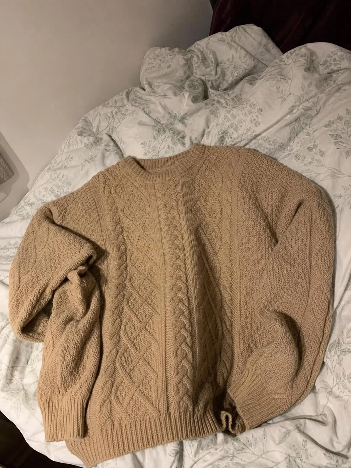 Source photo of a beige cable-knit sweater, 2 of 2, taken on a phone