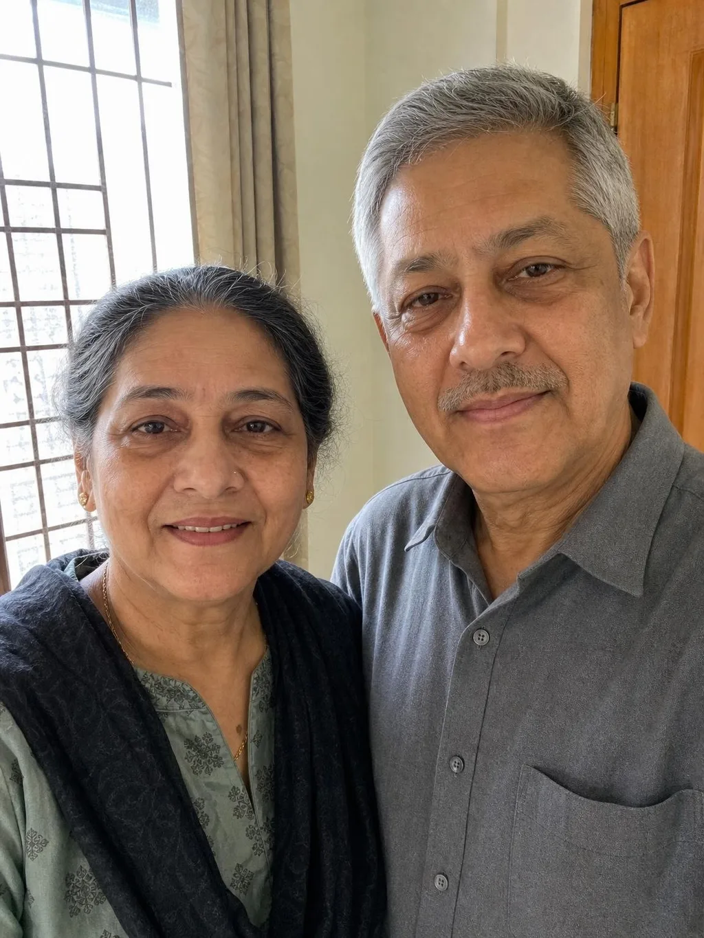 Input photo two: a selfie of an older couple taken indoors by a window