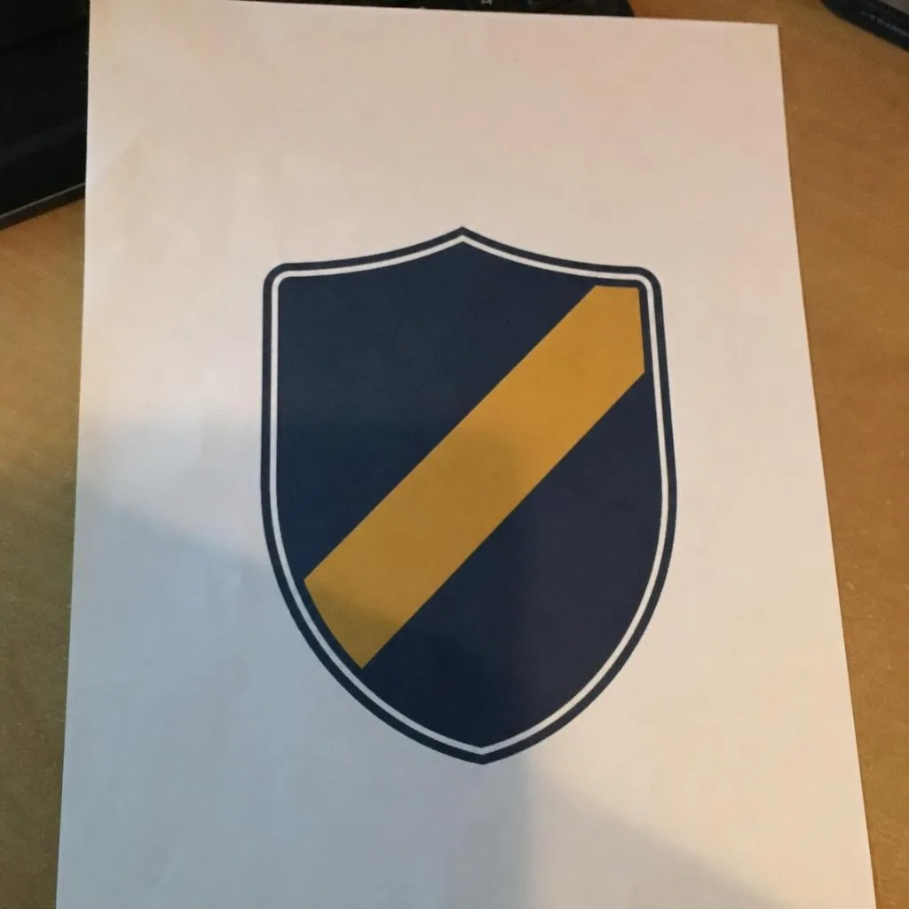 Source photo of a shield logo on a delivery van, 1 of 1, taken on a phone