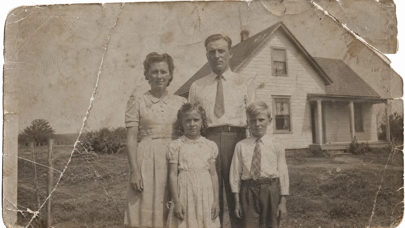 Source photo of a family outside their farmhouse, 1 of 1, taken on a phone