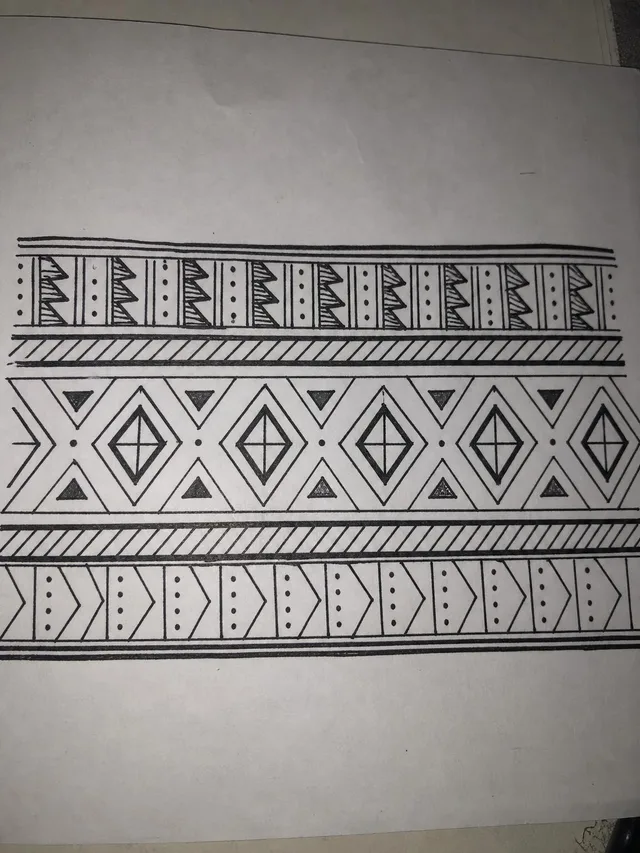 Hand-drawn ornamental band tattoo design on paper